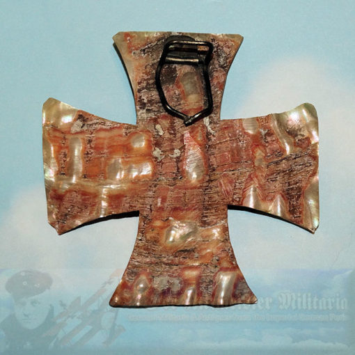 Elegant and uniquely displayed 1914 Iron Cross 2nd Class. A mother-of-pearl shell section, measuring 3 ½" x 3 ½," has been cut into the shape of an Iron Cross. It serves as a illuminating background or frame for an actual 1914 Iron Cross 2nd Class.