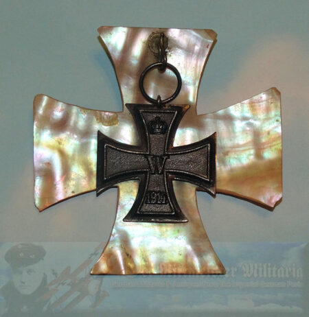 Elegant and uniquely displayed 1914 Iron Cross 2nd Class. A mother-of-pearl shell section, measuring 3 ½" x 3 ½," has been cut into the shape of an Iron Cross. It serves as a illuminating background or frame for an actual 1914 Iron Cross 2nd Class.